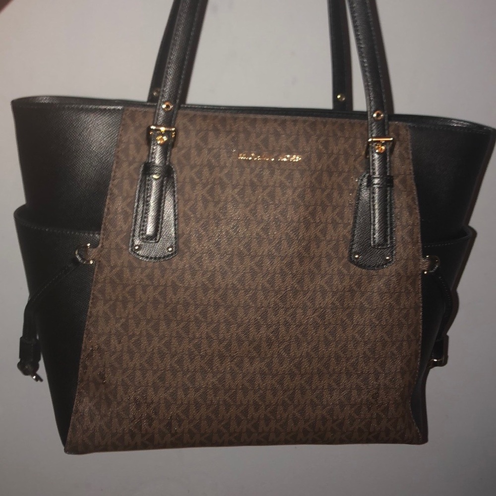 Authentic MK voyager tote. Price is firm
